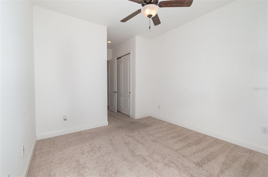 4911 Drawdy Court St. Cloud, FL 34772 - Photo 21 of 37 an empty room with a fan & a ceiling fan