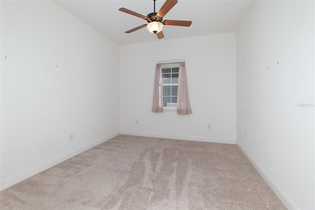 4911 Drawdy Court St. Cloud, FL 34772 - Photo 23 of 37 an empty room with windows and fan