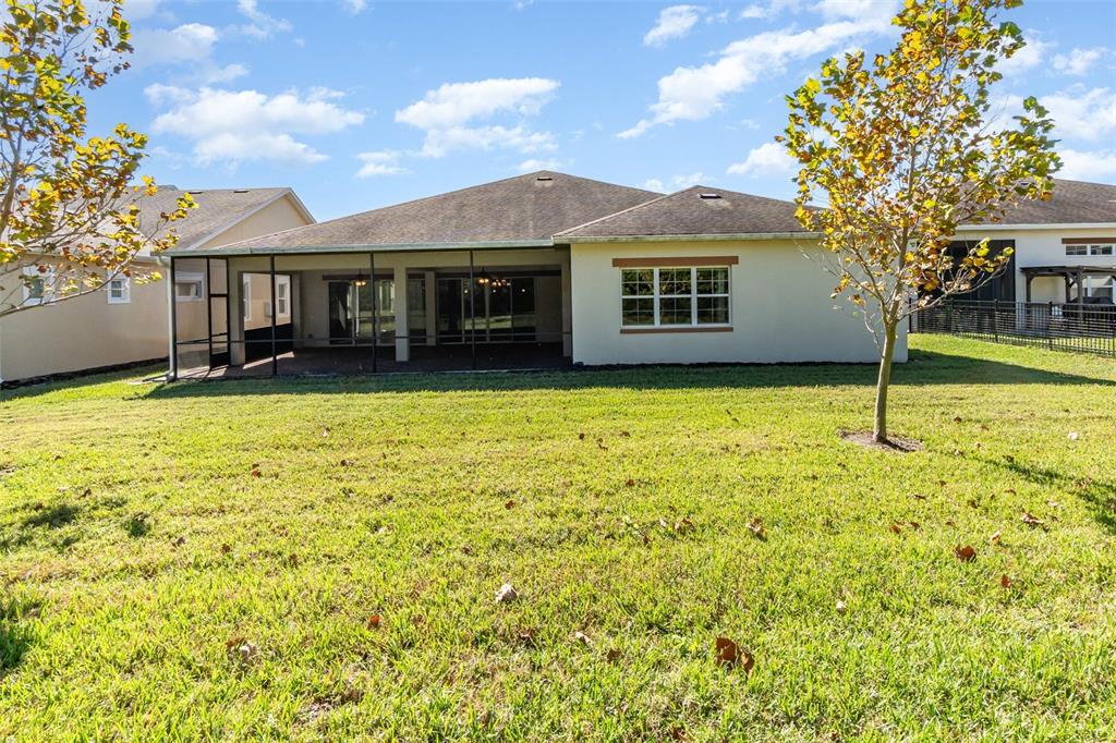 4911 Drawdy Court St. Cloud, FL 34772 - Photo 36 of 37 a view of a house with pool and a yard