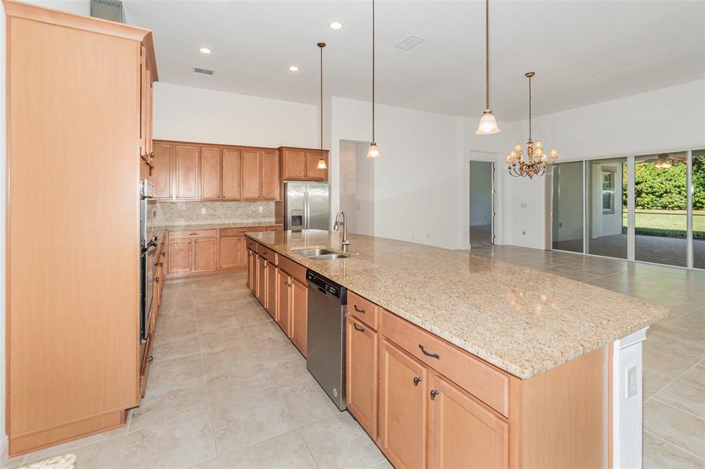 4911 Drawdy Court St. Cloud, FL 34772 - Photo 8 of 37 a kitchen with kitchen island a counter top space a sink appliances and a counter top space