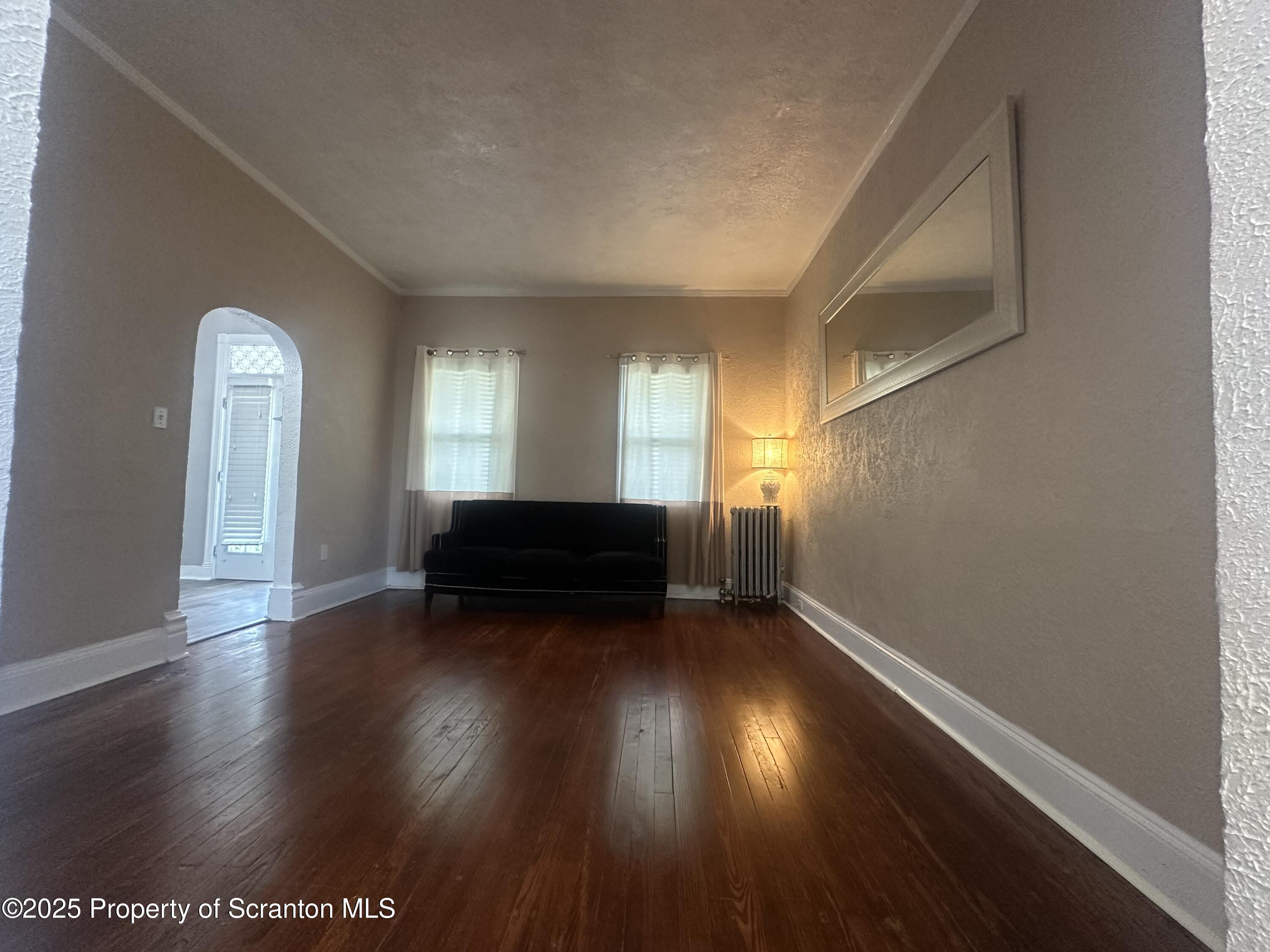 821 Maple Street Scranton, PA 18505 - Photo 3 of 21 a view of empty room with wooden floor and fan