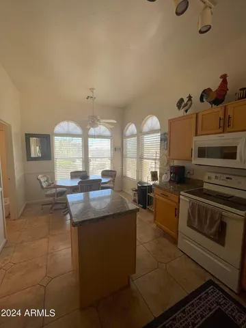 a kitchen with stainless steel appliances granite countertop a sink and a stove