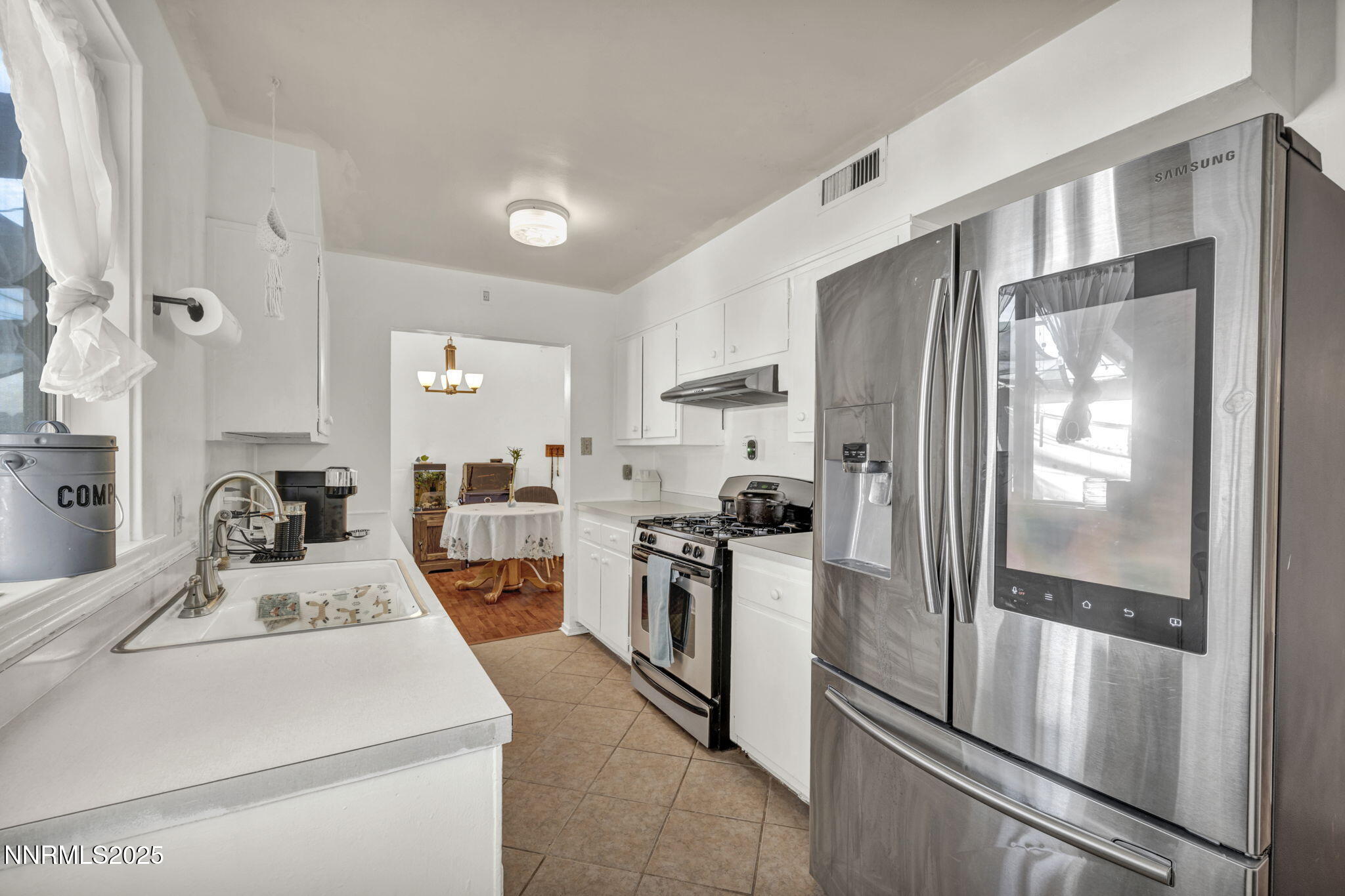 13623 Mt Baldy Street Reno, NV 89506 - Photo 37 of 46 a kitchen that has a refrigerator and a sink