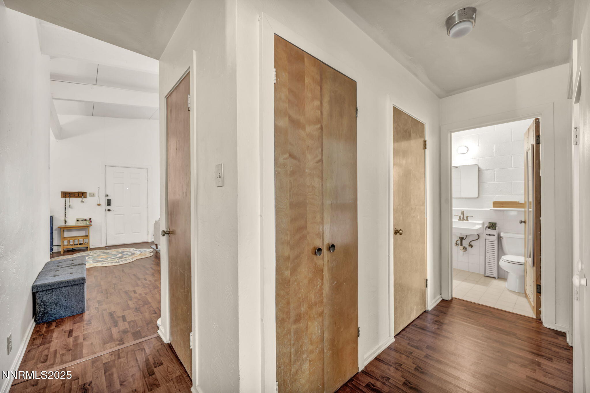 13623 Mt Baldy Street Reno, NV 89506 - Photo 38 of 46 a view of a hallway with wooden floor and a bathroom