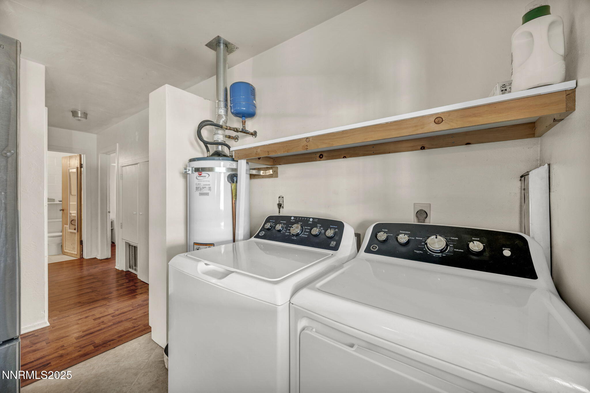 13623 Mt Baldy Street Reno, NV 89506 - Photo 45 of 46 a kitchen with a refrigerator a stove and wooden floor