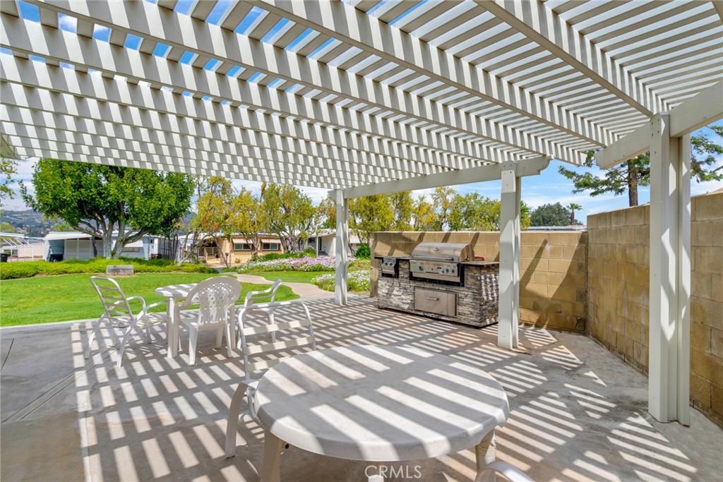 3500 Buchanan Street, Unit 73 Riverside, CA 92503 - Photo 25 of 30 a view of a chairs and table in backyard of the house