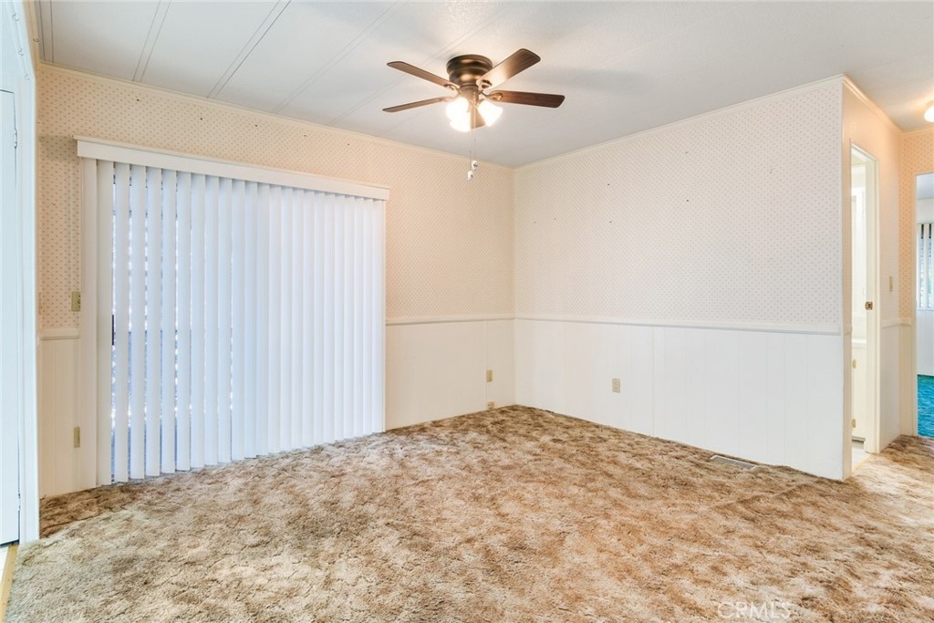3500 Buchanan Street, Unit 73 Riverside, CA 92503 - Photo 10 of 30 a view of a livingroom with a ceiling fan and a window