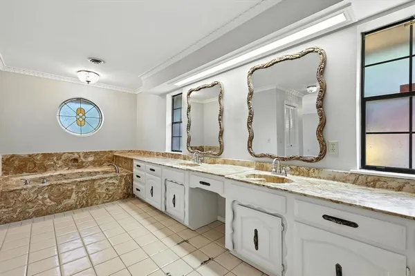 a spacious bathroom with a granite countertop sink mirror and a