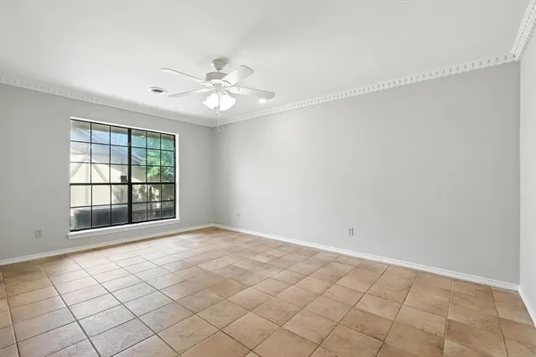 a view of an empty room with a fireplace and window