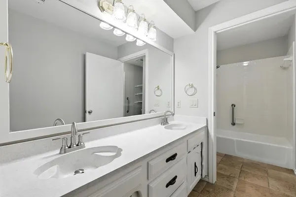 a view of a big room with windows and chandelier fan