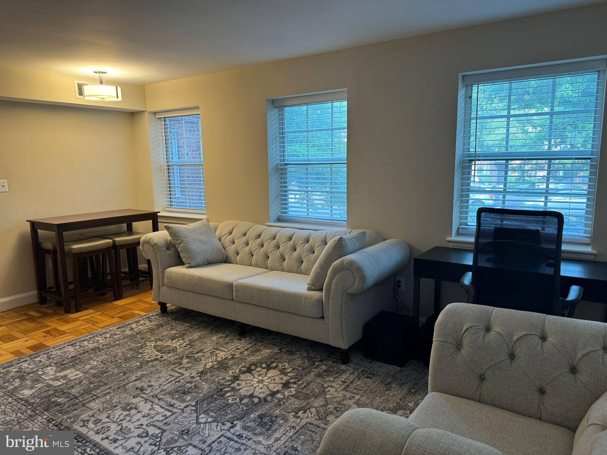 2107 North Scott Street, Unit 67 Arlington, VA 22209 - Photo 14 of 16 a living room with furniture and a flat screen tv