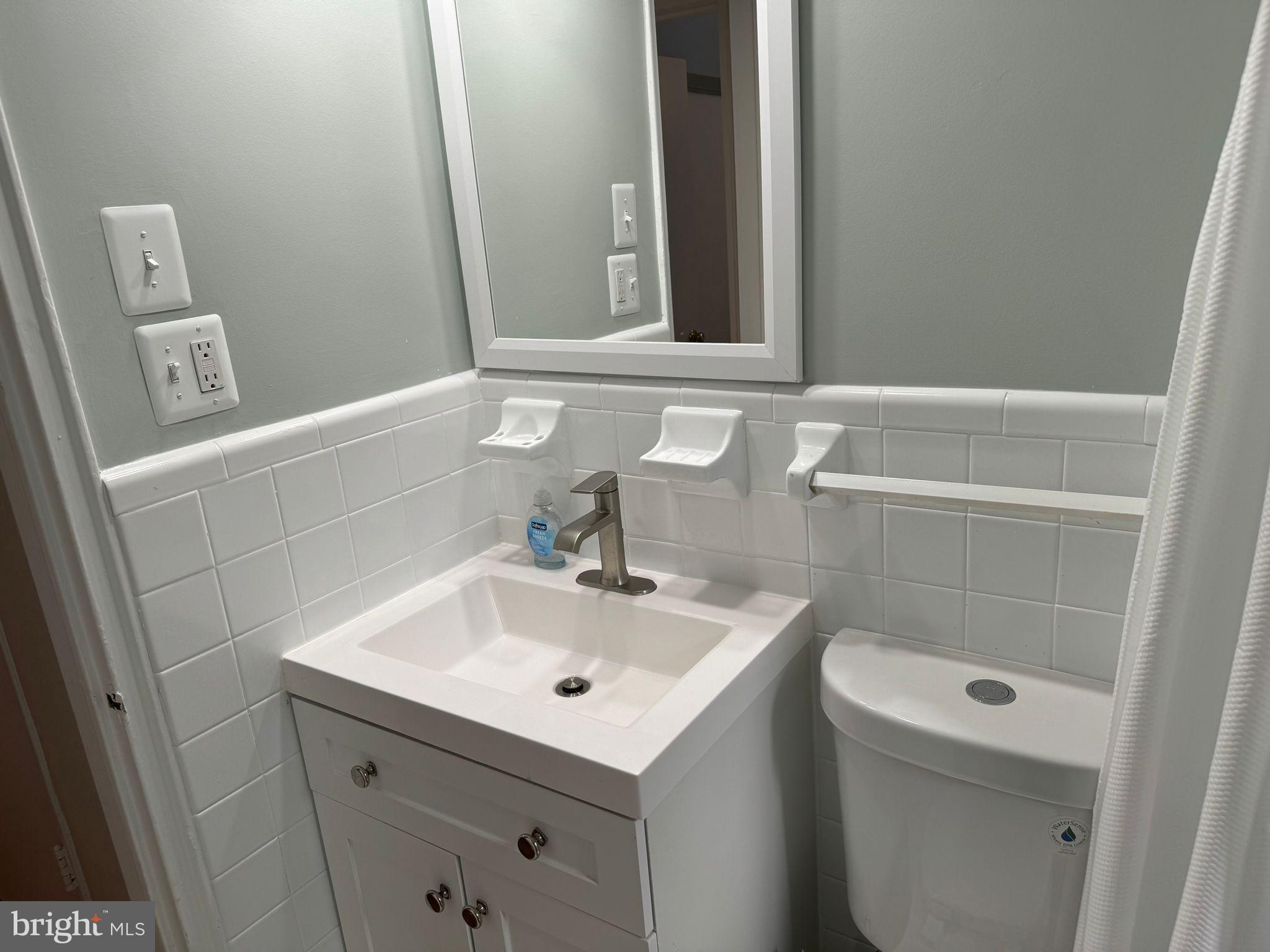 2107 North Scott Street, Unit 67 Arlington, VA 22209 - Photo 6 of 16 a bathroom with a sink and a mirror