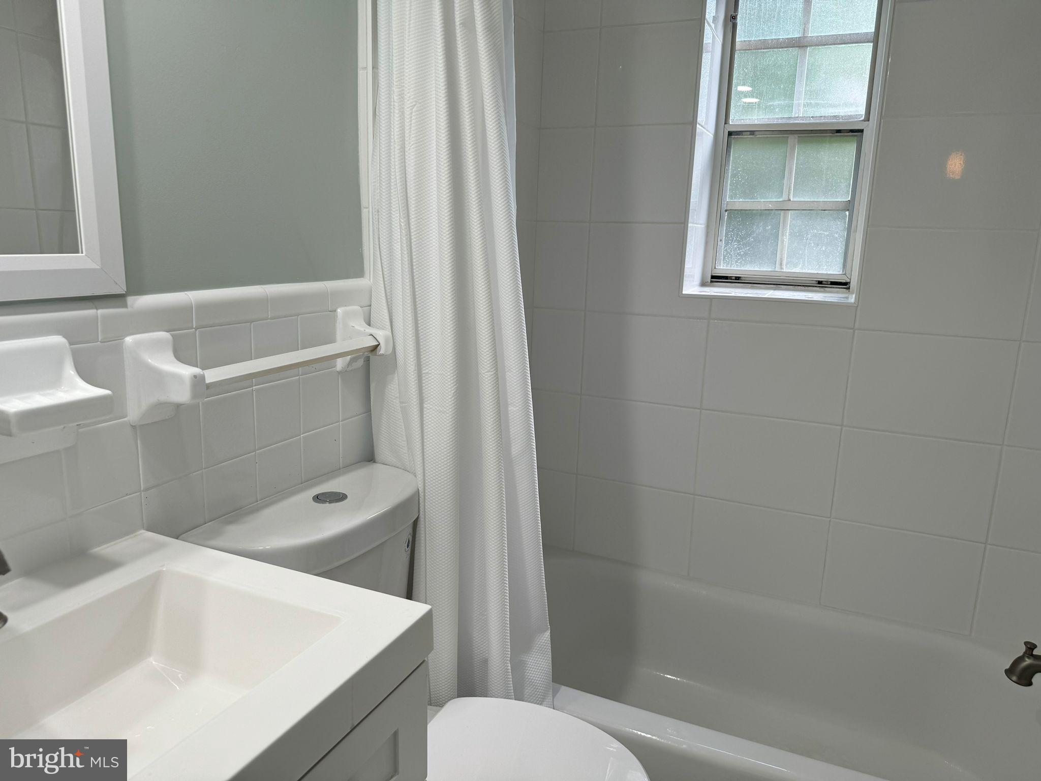 2107 North Scott Street, Unit 67 Arlington, VA 22209 - Photo 7 of 16 a bathroom with a sink a toilet and shower
