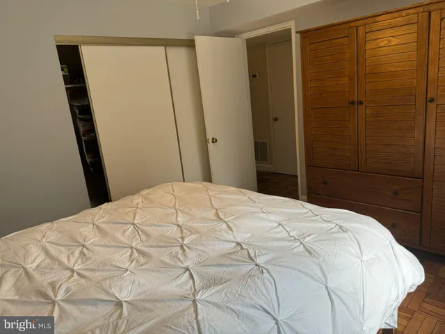 a bedroom with a bed and a mirror