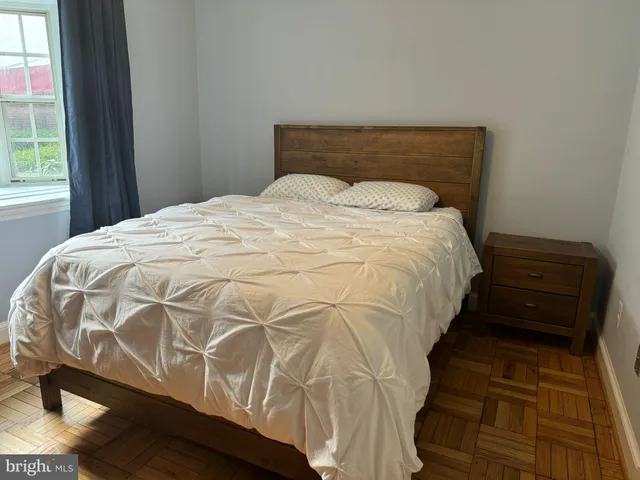 a bed sitting in a bedroom next to a window