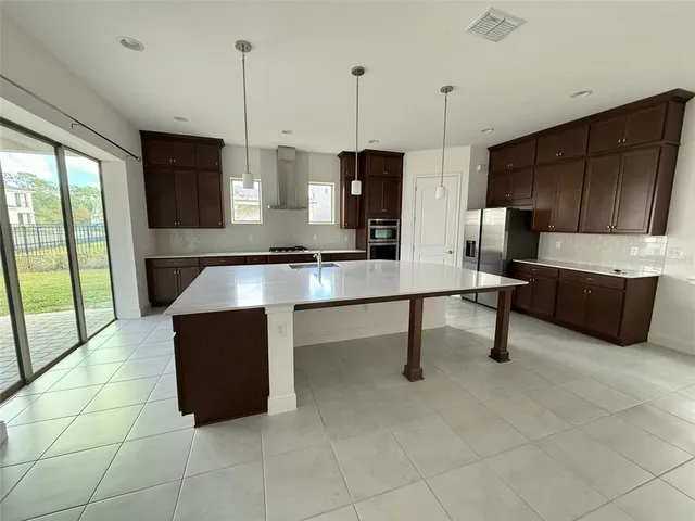 a room with furniture and a view of kitchen