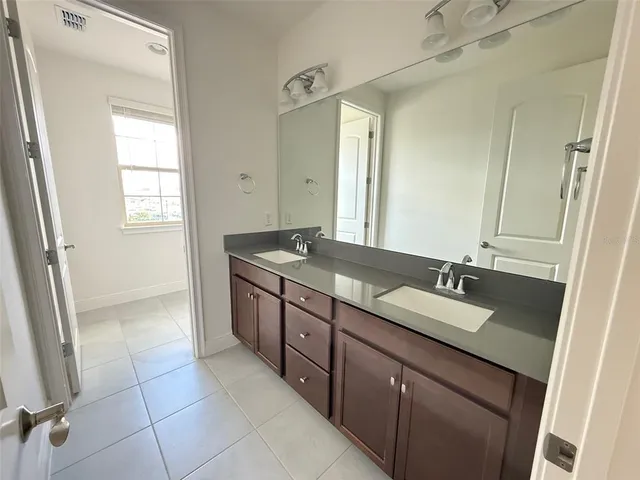 an empty room with windows and a ceiling fan