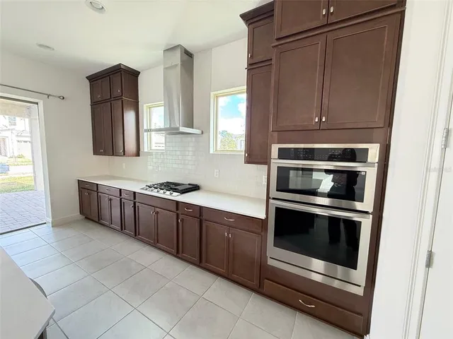 a kitchen with stainless steel appliances granite countertop a stove and a microwave