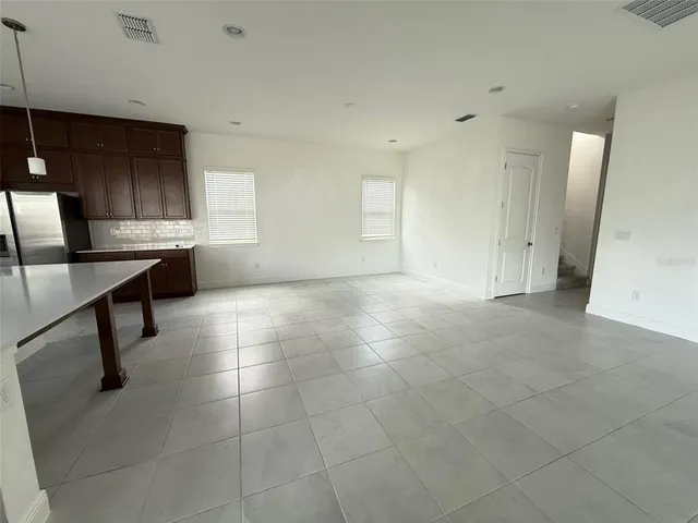 an empty room with closet and a chandelier fan