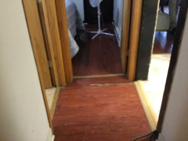 a kitchen with a clock on the wall and cabinets
