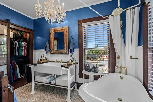 a front view of a house with a garden and trees