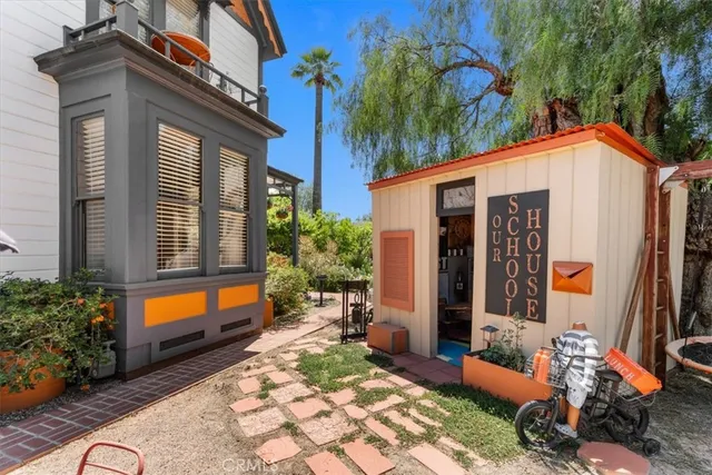 a bathroom with a granite countertop sink vanity mirror and toilet