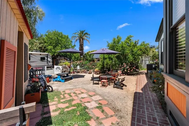 a view of a dining room with furniture and a potted plant