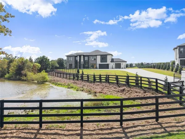 a view of a house with swimming pool and a yard