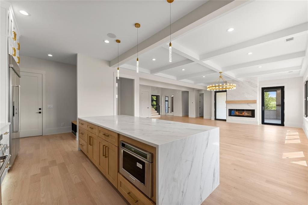 2031 Jones Phillips Road Dacula, GA 30019 - Photo 21 of 89 a large kitchen with stainless steel appliances granite countertop a large counter top and a stove