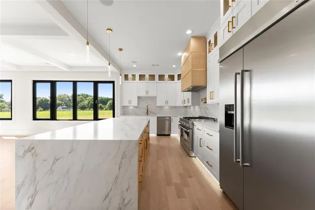 a spacious bathroom with a double vanity sink a mirror a bathtub and a shower