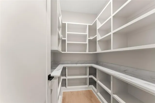 a kitchen with stainless steel appliances granite countertop a stove and a white cabinets