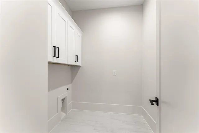 a view of an empty room with window and fire place