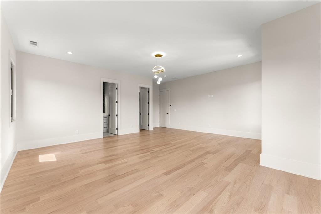 2031 Jones Phillips Road Dacula, GA 30019 - Photo 38 of 89 a view of an empty room with wooden floor and a ceiling fan