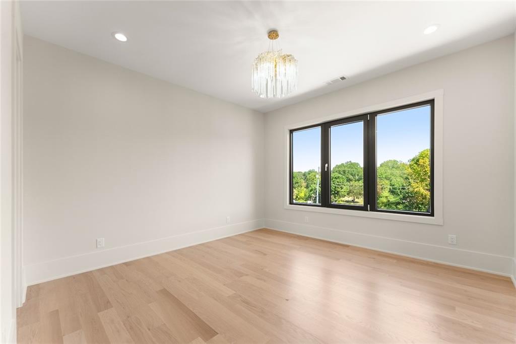 2031 Jones Phillips Road Dacula, GA 30019 - Photo 42 of 89 wooden floor in an empty room with a window