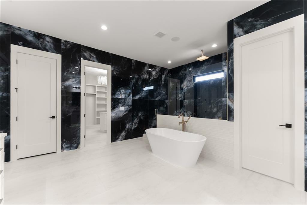 2031 Jones Phillips Road Dacula, GA 30019 - Photo 50 of 89 a bathroom with a bathtub and a shower
