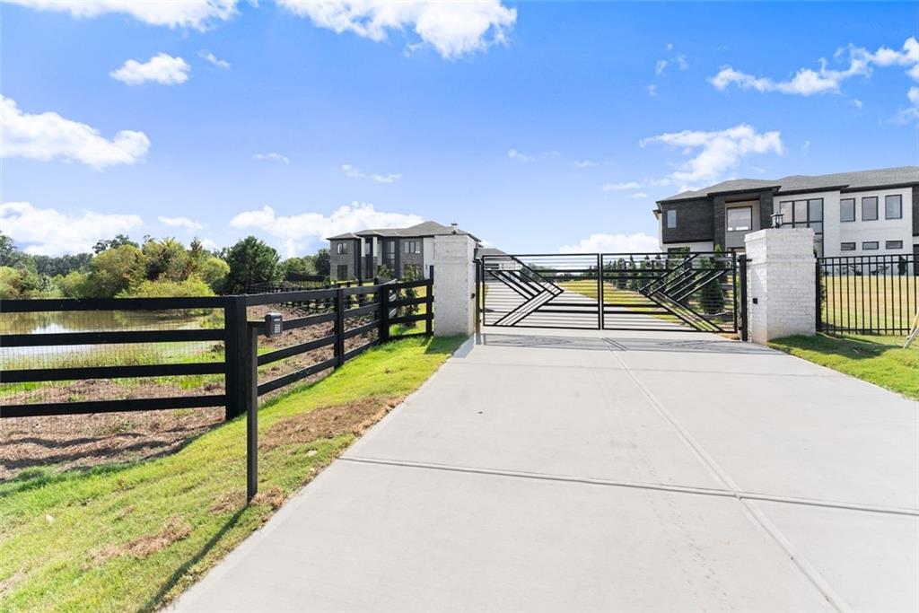 2031 Jones Phillips Road Dacula, GA 30019 - Photo 5 of 89 a view of a pathway with a wrought fence