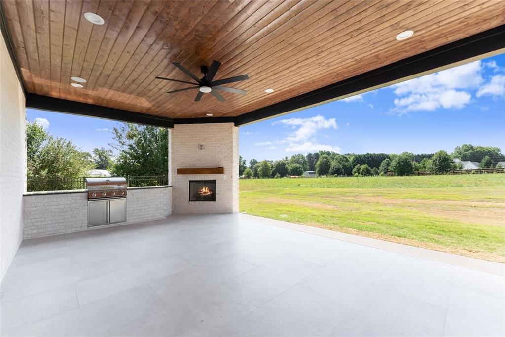2031 Jones Phillips Road Dacula, GA 30019 - Photo 55 of 89 a view of a livingroom with a fireplace a swimming pool and outdoor space