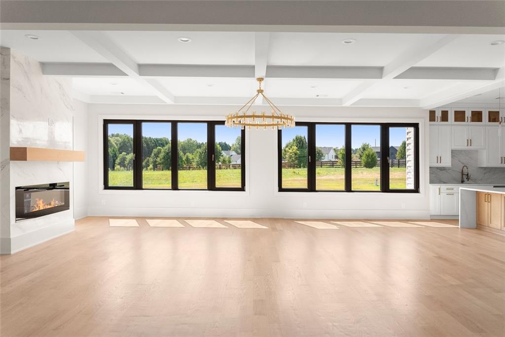 2031 Jones Phillips Road Dacula, GA 30019 - Photo 62 of 89 a view of an empty room with a fireplace and a window