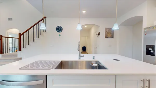 a kitchen with granite countertop a sink a stove and cabinets