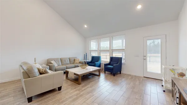 a living room with furniture a large window and a couch