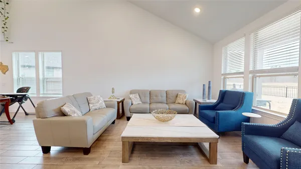 a living room with furniture and wooden floor