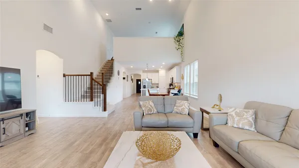 a living room with furniture a flat screen tv and a window