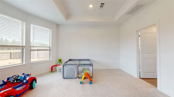 a view of a bedroom with furniture