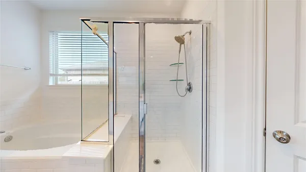 a bathroom with a tub and a shower