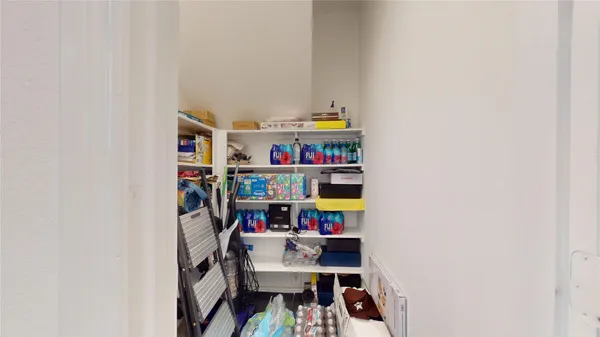 an empty room with a windows and cabinet