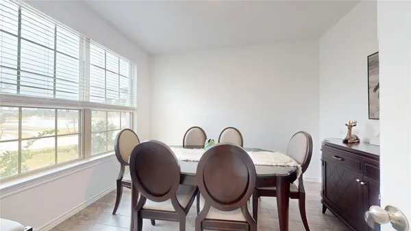 a dining room with furniture and mirror