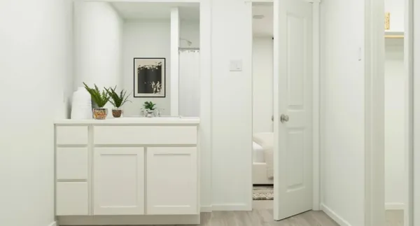 a bedroom with furniture and a potted plant