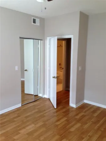 a view of empty room with wooden floor