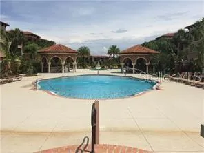 a view of house with outdoor space and swimming pool