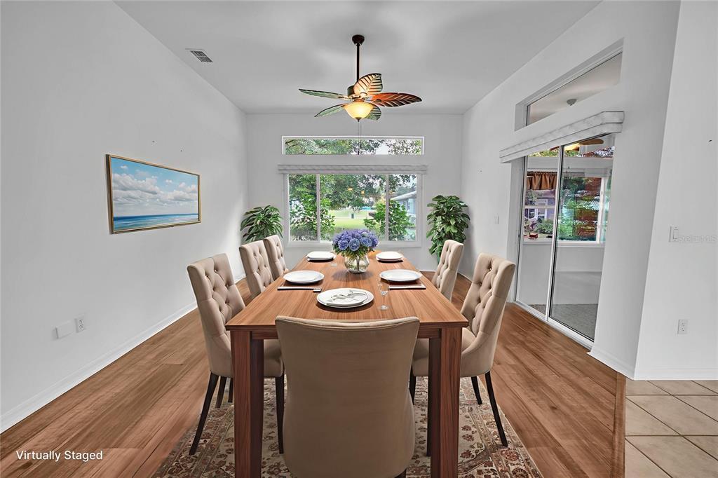 10317 Southwest 63rd Avenue Ocala, FL 34476 - Photo 14 of 46 a dining room with furniture a window and a rug